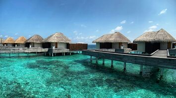 Overwater villas on a clear lagoon in the Maldives
