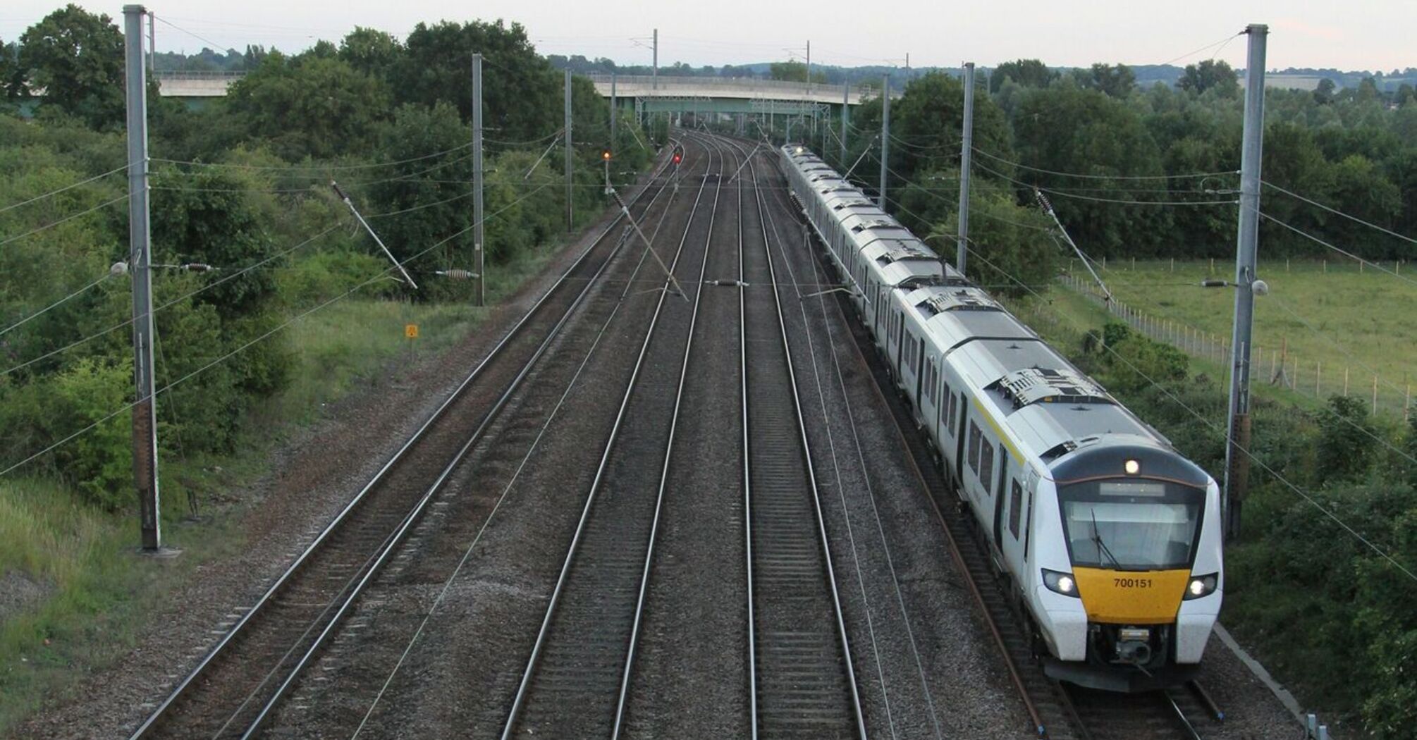 Passenger train travelling along multi-track railway through rural Norfolk