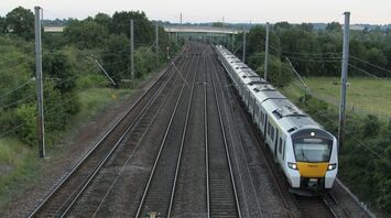 Passenger train travelling along multi-track railway through rural Norfolk