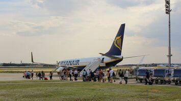 Passengers boarding a Ryanair aircraft on the tarmac