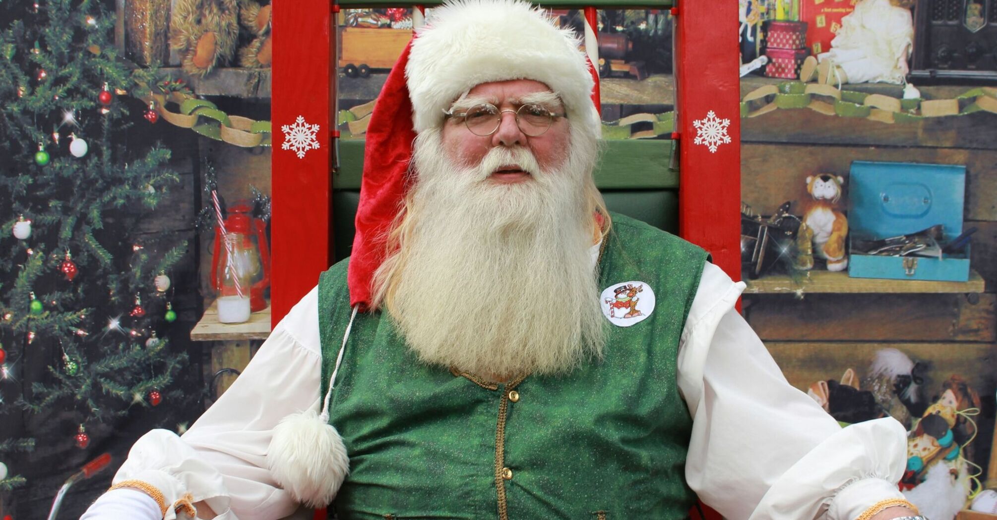 Santa Claus sitting in a decorated Christmas setting