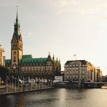 Hamburg city centre with the Rathaus overlooking the canal at sunset