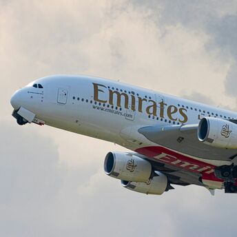 Emirates A380 departing under cloudy skies
