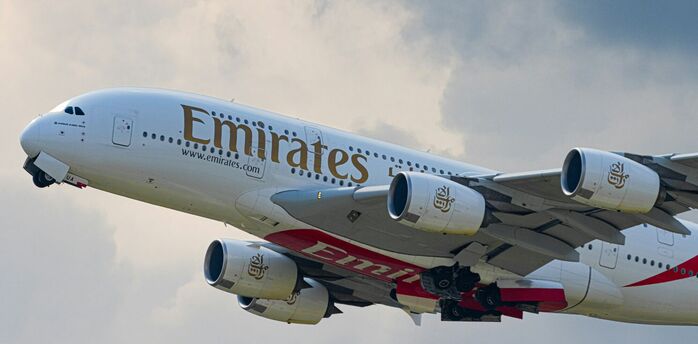 Emirates A380 departing under cloudy skies