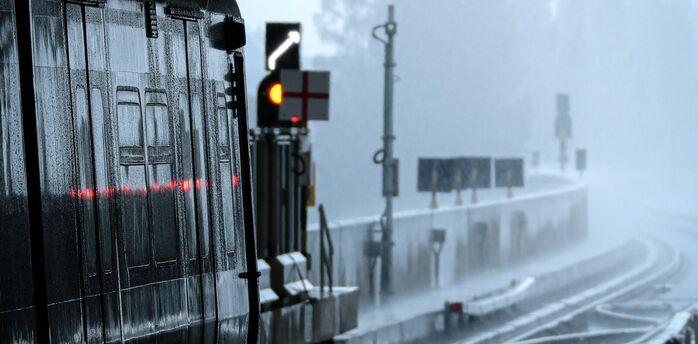 Rain-soaked train platform during severe weather