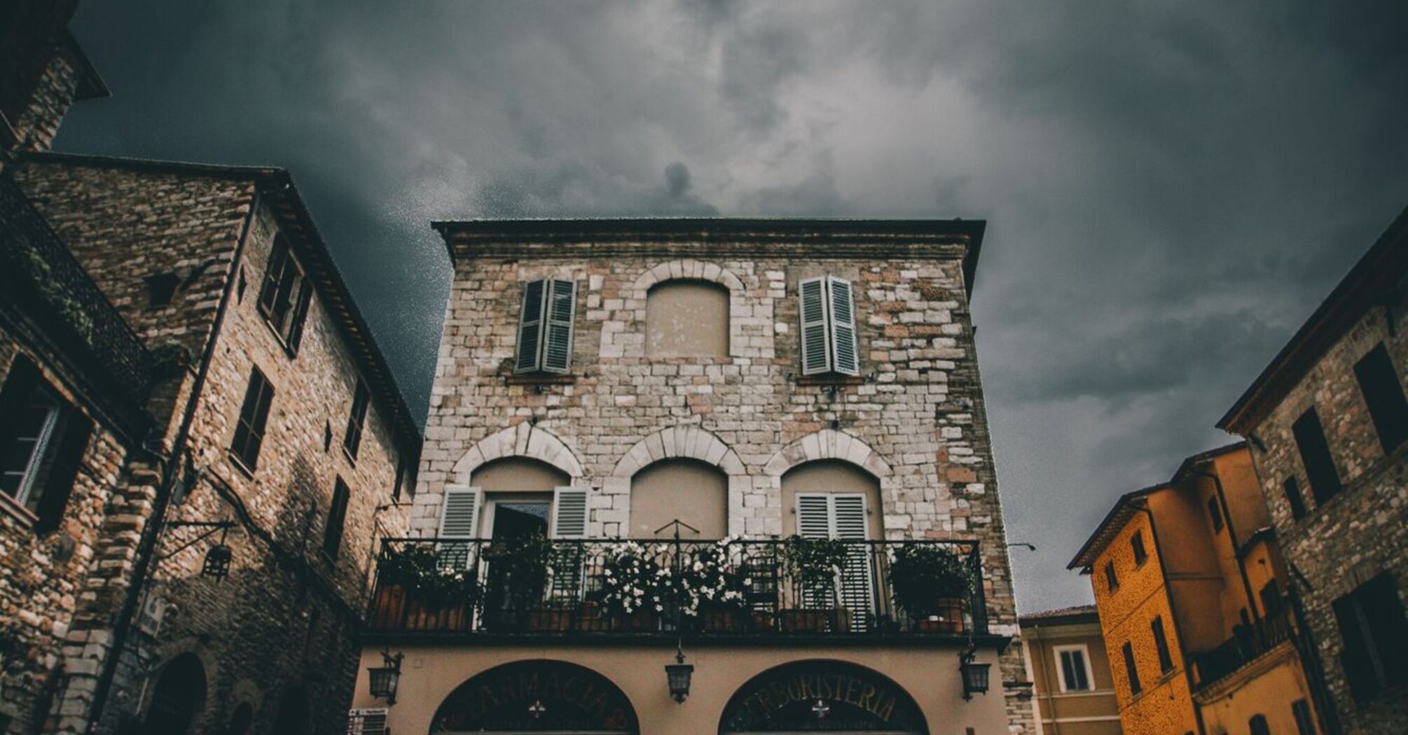 Dark clouds over historic buildings during strong winds