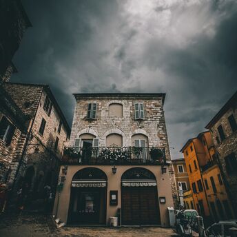 Dark clouds over historic buildings during strong winds