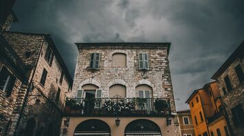 Dark clouds over historic buildings during strong winds