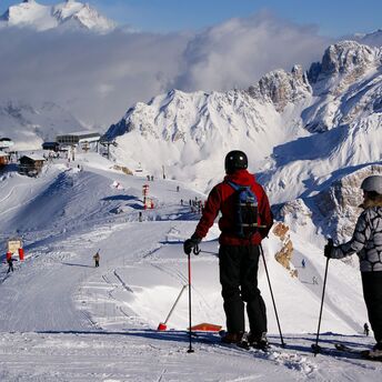 Skiers overlooking the slopes in Courchevel