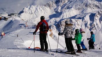Skiers overlooking the slopes in Courchevel
