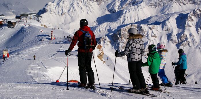 Skiers overlooking the slopes in Courchevel