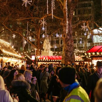 Crowded Christmas market during winter evening travel period