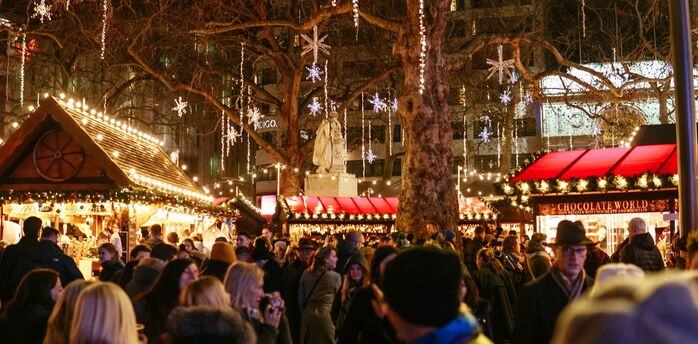 Crowded Christmas market during winter evening travel period