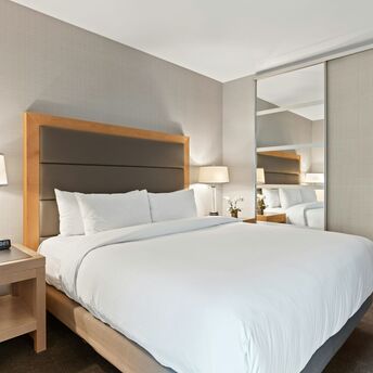 Modern hotel room with neutral decor and large bed