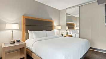 Modern hotel room with neutral decor and large bed