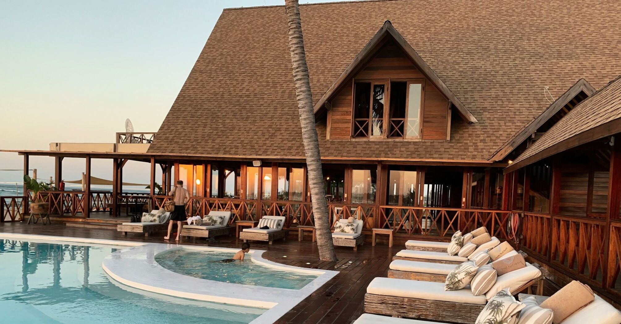 Tropical resort-style pool with wooden terrace