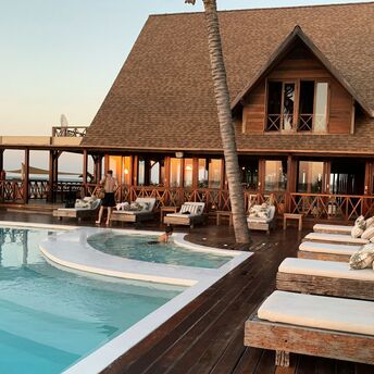 Tropical resort-style pool with wooden terrace