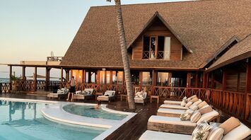 Tropical resort-style pool with wooden terrace