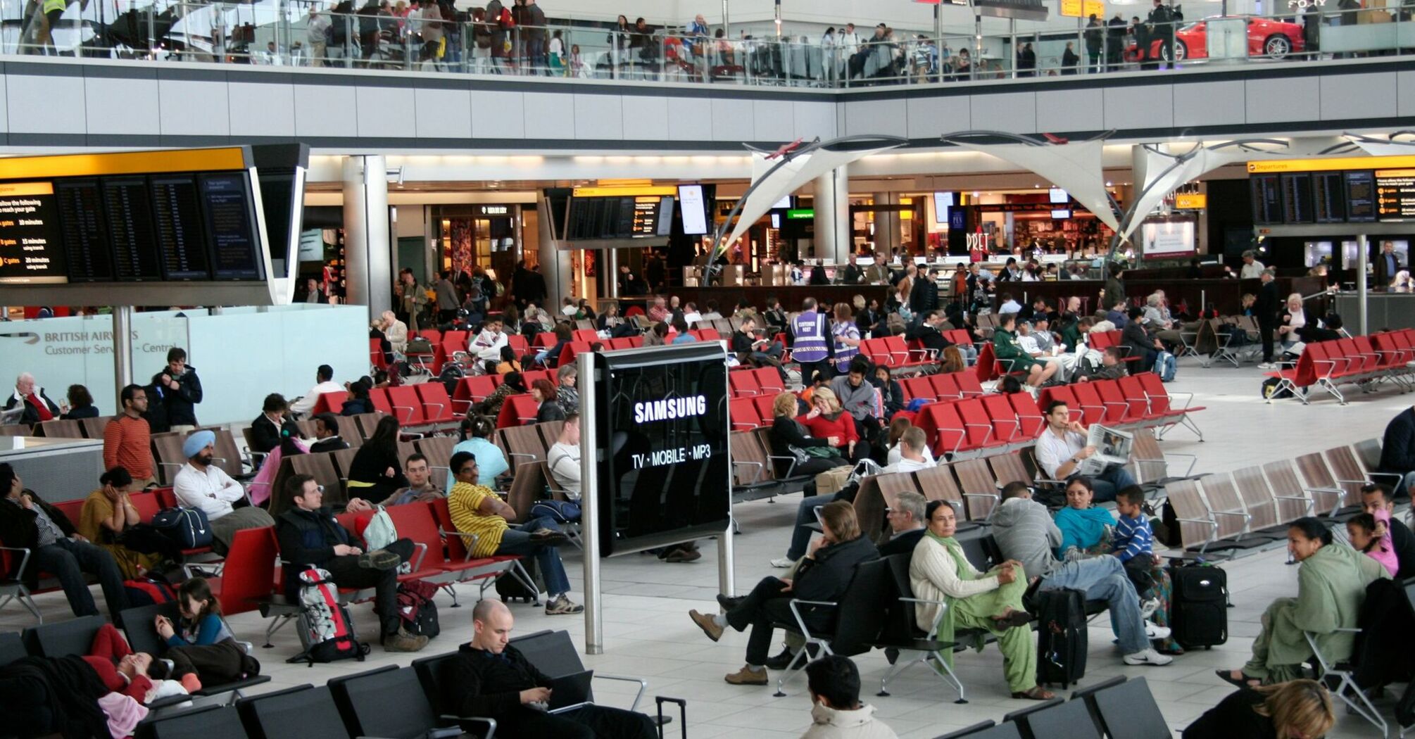 Passengers waiting in an airport departures area