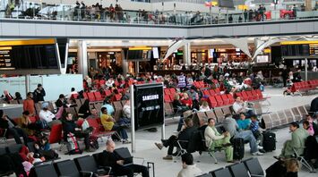 Passengers waiting in an airport departures area