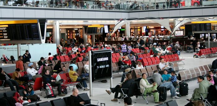 Passengers waiting in an airport departures area