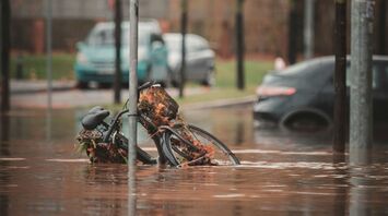 Flooded street with submerged bicycle and traffic sign