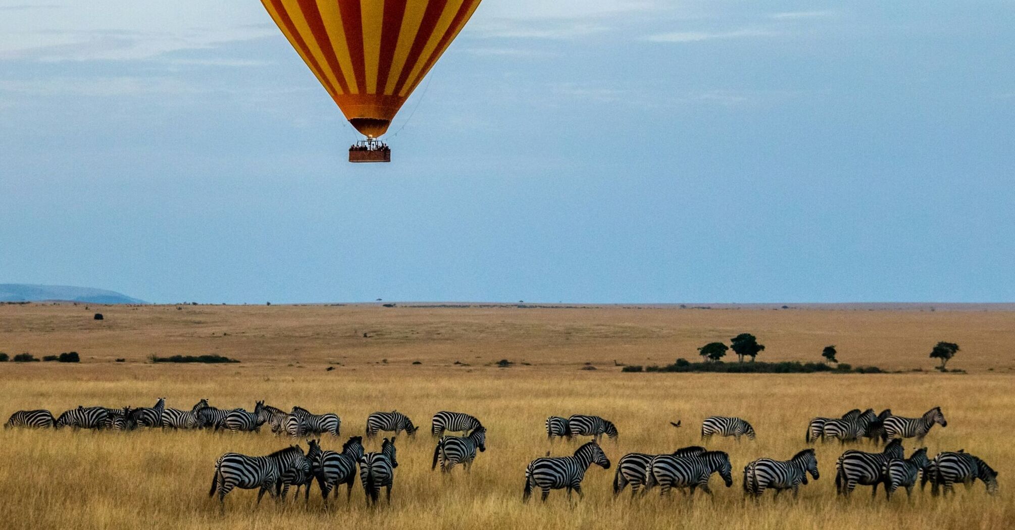Hot air balloon over safari landscape in Kenya