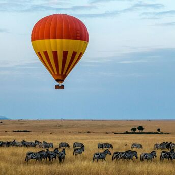 Hot air balloon over safari landscape in Kenya