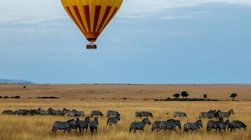 Hot air balloon over safari landscape in Kenya