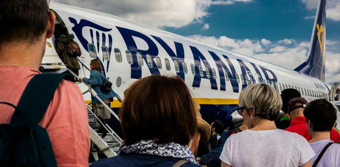Passengers boarding a Ryanair aircraft at the airport.