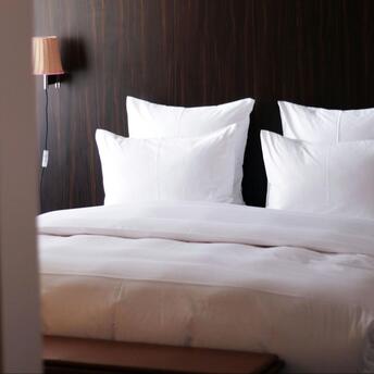 Modern hotel room with fresh white bedding