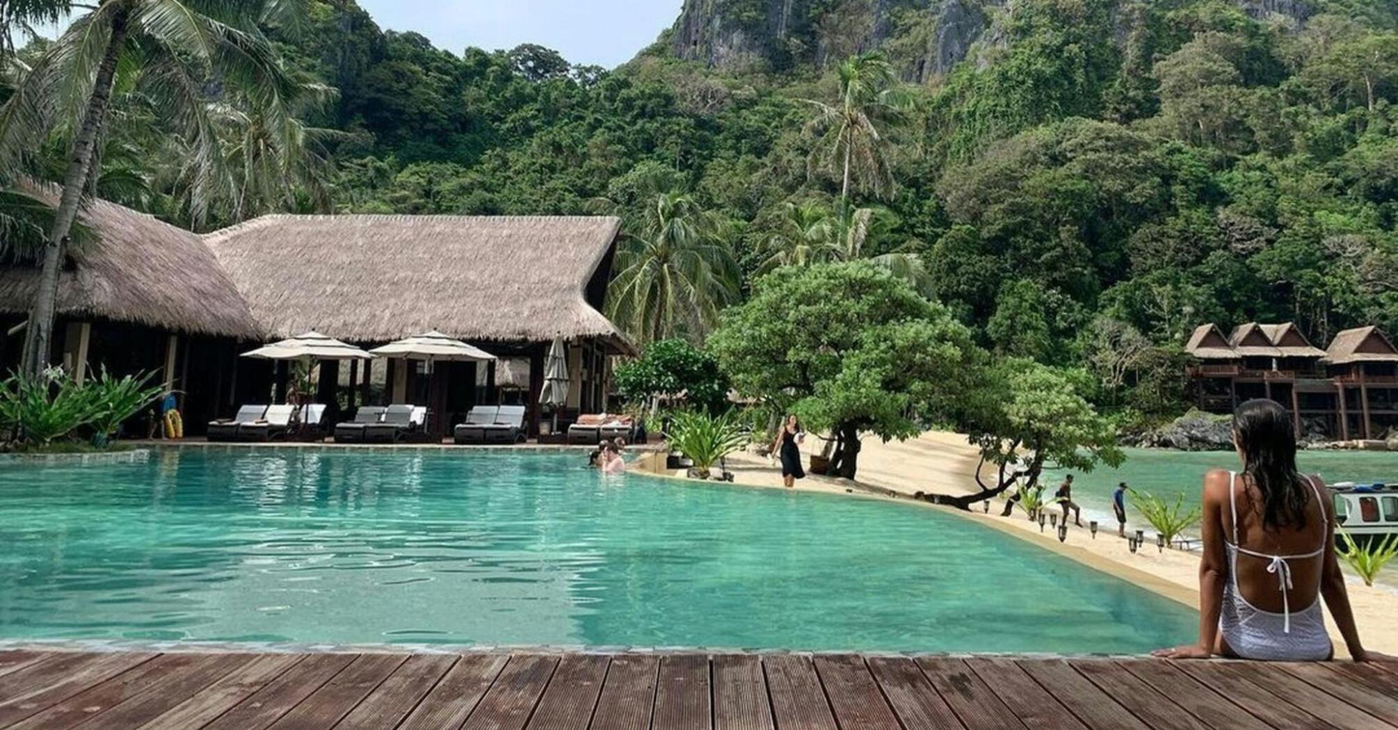 Resort pool set within tropical landscape