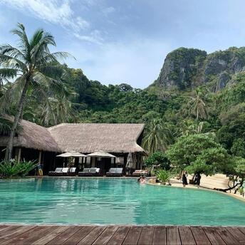 Resort pool set within tropical landscape