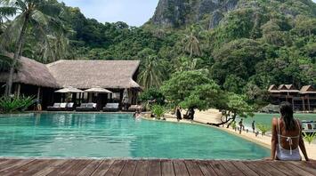 Resort pool set within tropical landscape
