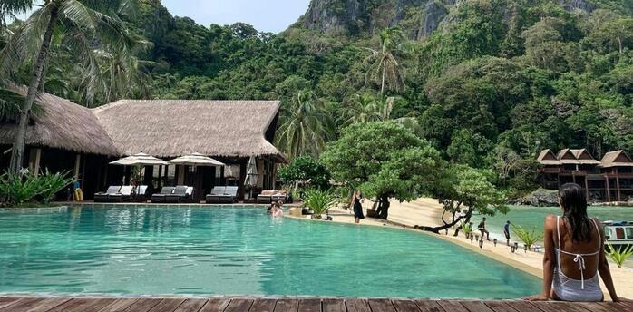 Resort pool set within tropical landscape