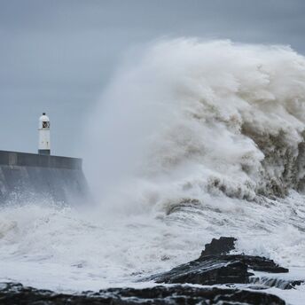 Rough sea wave under dark storm clouds