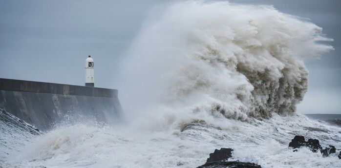 Rough sea wave under dark storm clouds