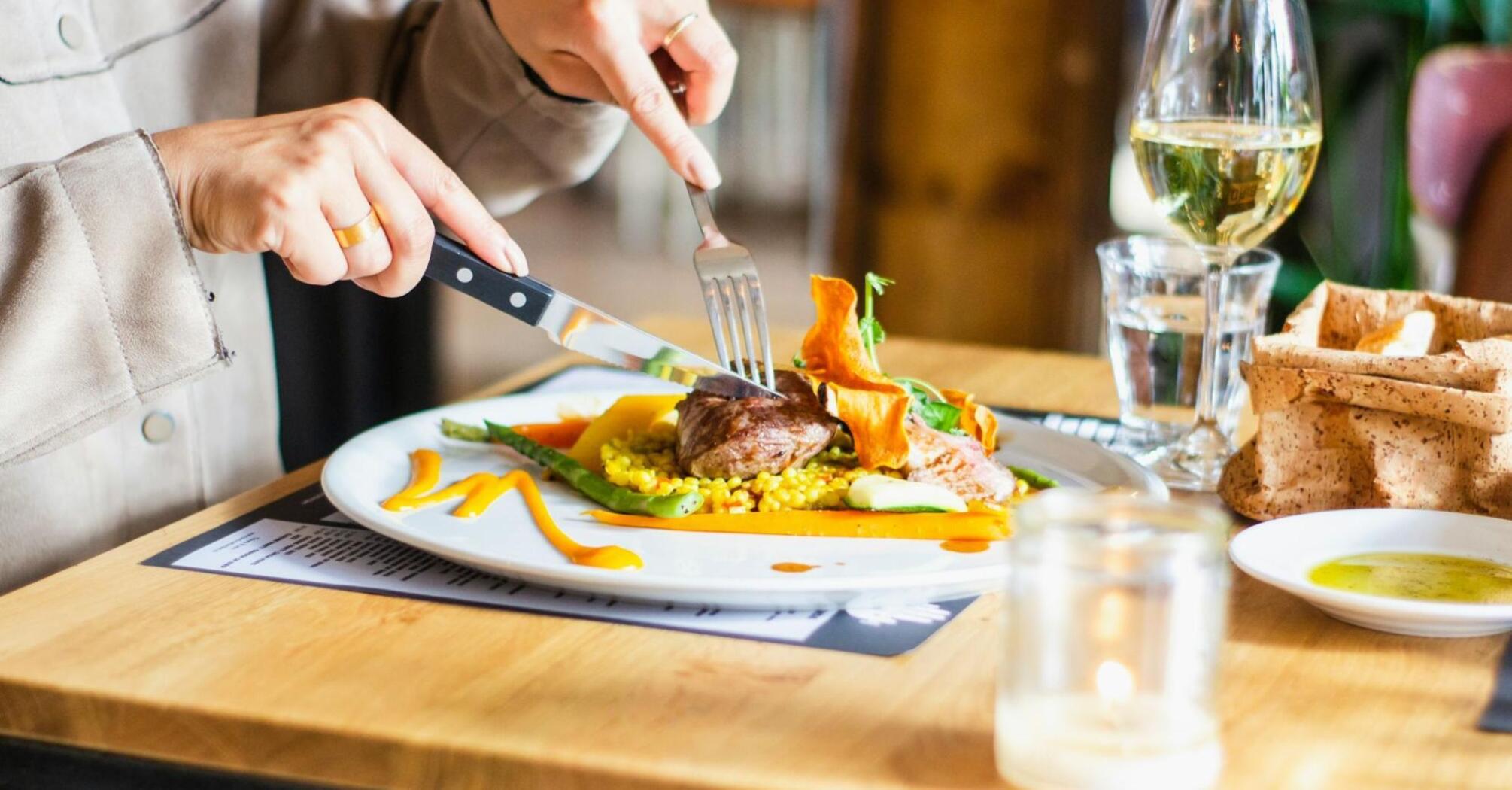 A diner enjoying a plated seasonal restaurant dish