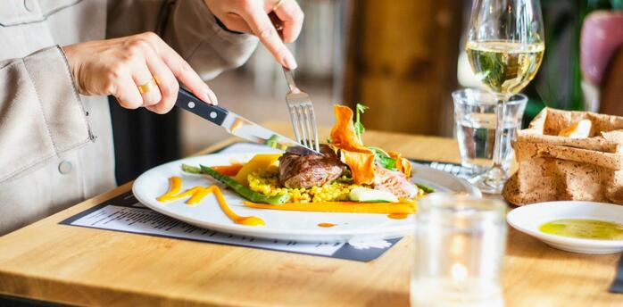 A diner enjoying a plated seasonal restaurant dish