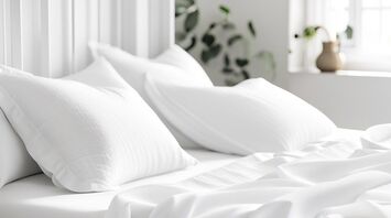 Fresh white bedding in a bright hotel room