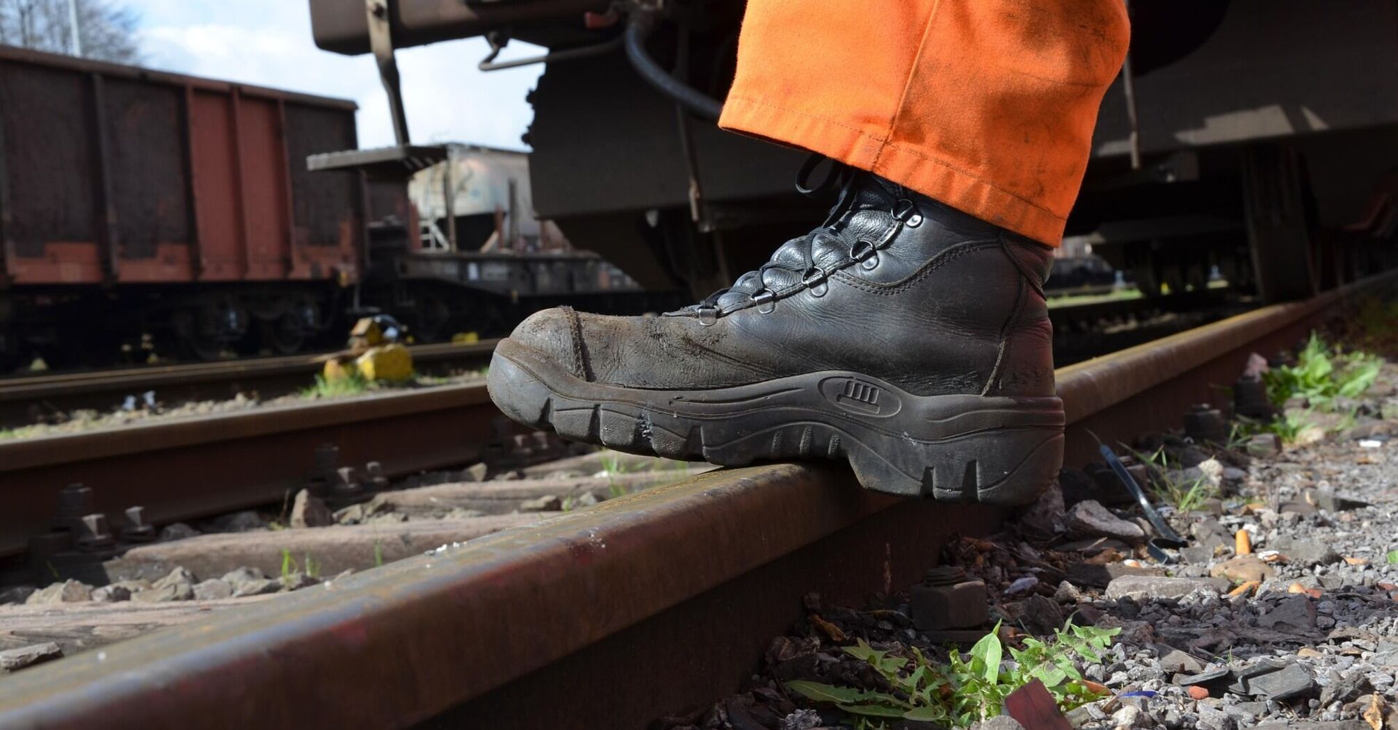 Rail worker inspecting track during maintenance