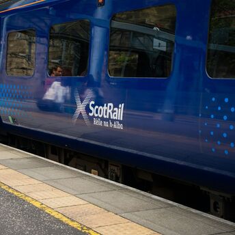 ScotRail train standing at a station platform in Scotland