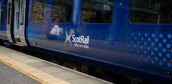 ScotRail train standing at a station platform in Scotland