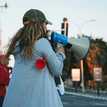 A protester using a megaphone during a strike demonstration