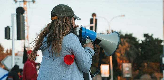 A protester using a megaphone during a strike demonstration