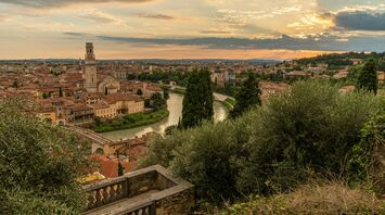 Sunset over Verona’s historic rooftops and the Adige River as seen from a hillside viewpoint
