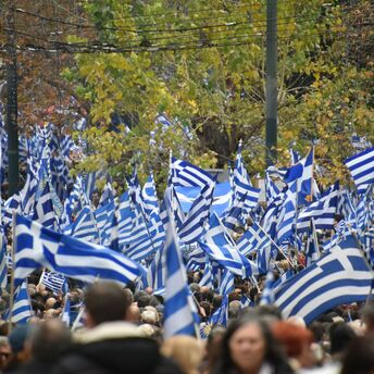 Large crowd carrying Greek flags during demonstrations in Greece
