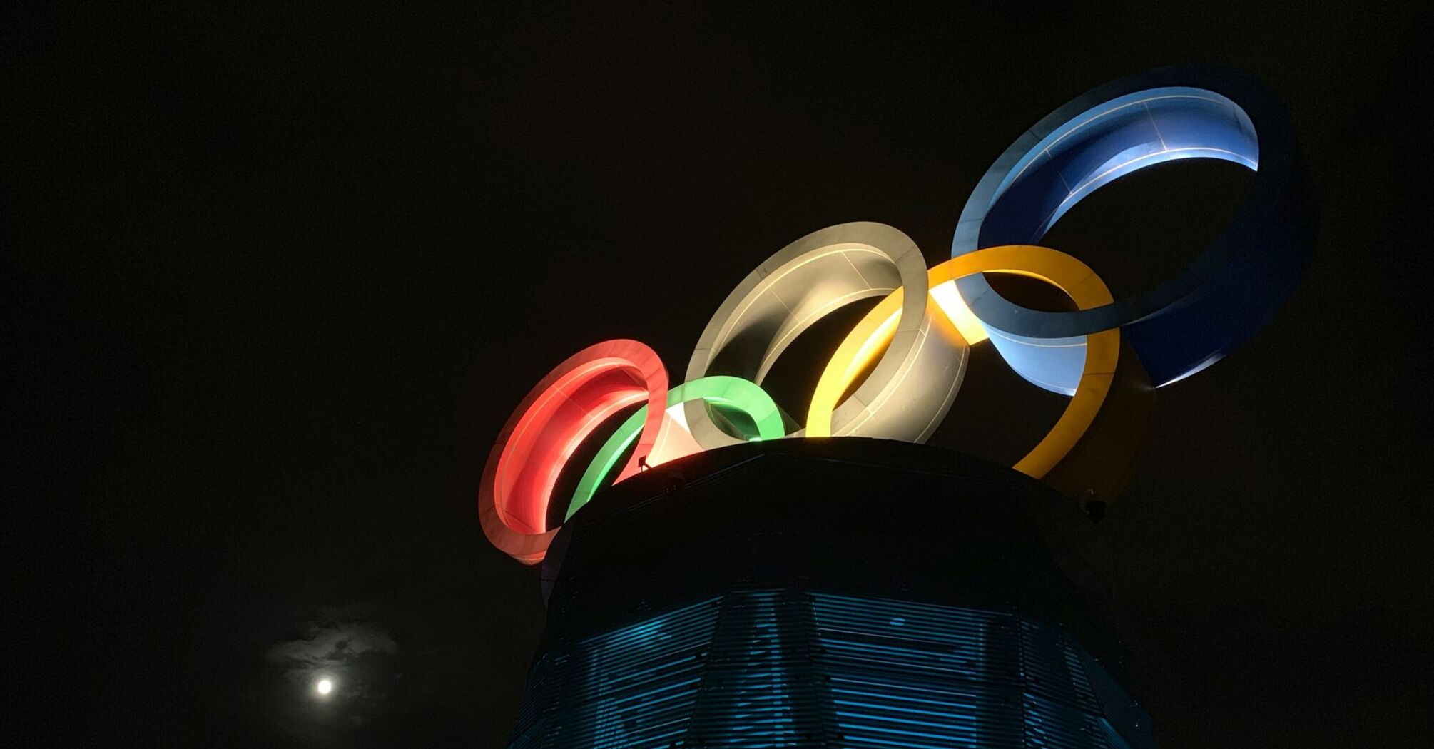 Illuminated Olympic rings installation at night