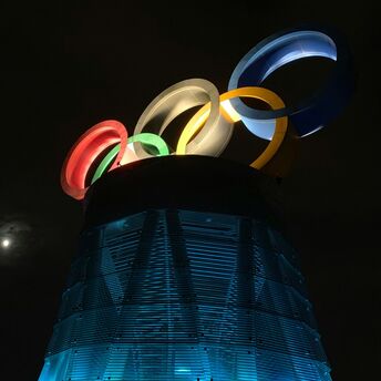 Illuminated Olympic rings installation at night