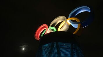 Illuminated Olympic rings installation at night